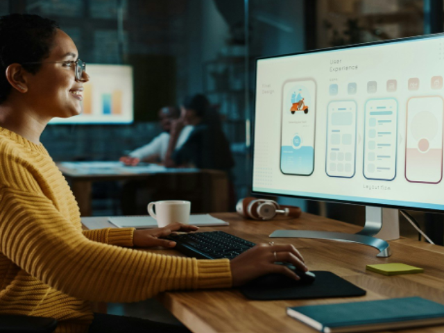 Photo of a UX designer seated at their desk
